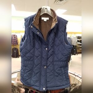 Quilted vest with contrast lining.